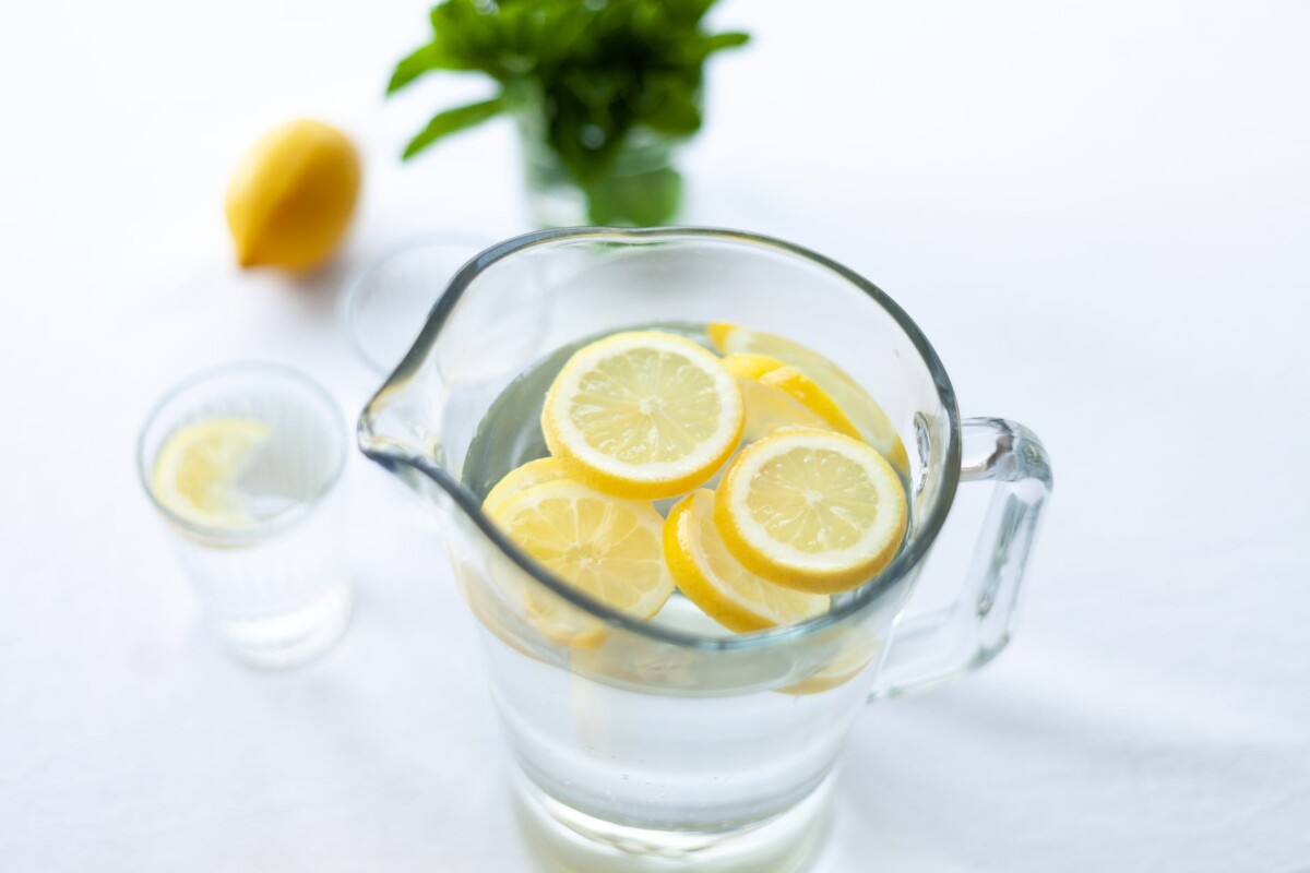 sliced lemon fruit in glass picher